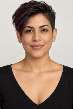 Fictional androgynous alternative model with tan skin and a short plum-streaked undercut